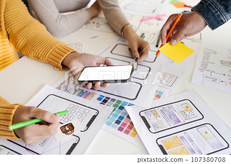 team of UI UX web designer are working together to develop mobile responsive websites. Mobile Mockup 107380708