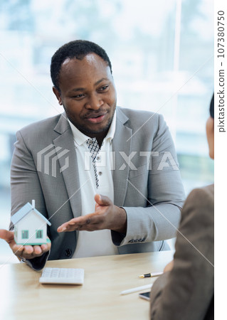 Real Estate Agent and client talking about Property insurance and security concept about house to client before sign contract 107380750