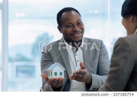 Real Estate Agent and client talking about Property insurance and security concept about house to client before sign contract 107380754