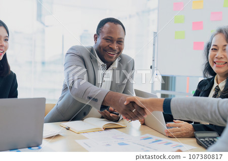 Happy mature business man handshaking corporate client, making partnership with partner investor 107380817