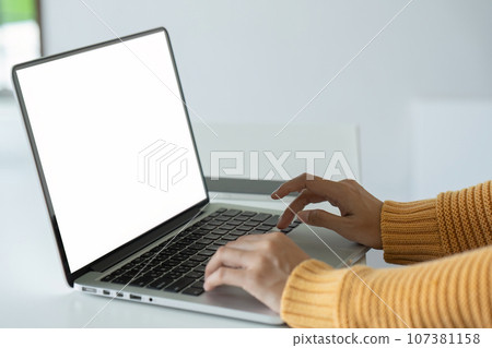 young woman working on laptop with blank screen with copy space screen for your advertising text message in office young woman working on laptop with blank screen with copy space screen for your advertising text message in office 107381158