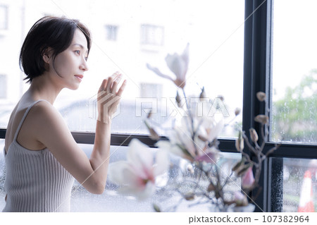 A woman looking out from the window side A woman looking out from the window side 107382964