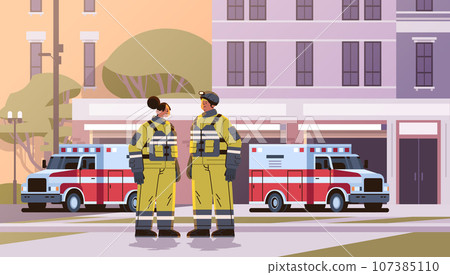 firefighters in uniform standing near fire station building department house facade and red emergency vehicles horizontal firefighters in uniform standing near fire station building department house facade and red emergency vehicles horizontal 107385110