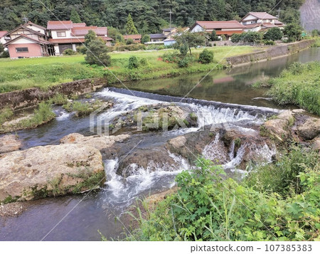 Rural area along a mountain stream in early autumn 107385383