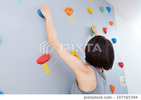 Middle-aged woman doing bouldering Middle-aged woman doing bouldering 107385394
