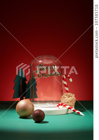 Glass transparent cage decorated with the inscription merry christmas, candy canes, christmas pine and baubles. Elegant holiday season social post digital Glass transparent cage decorated with the inscription merry christmas, candy canes, christmas pine and baubles. Elegant holiday season social post digital 107385718