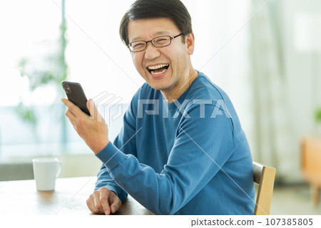 Senior man calling on smartphone 107385805