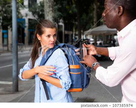Guy with stolen wallet running away Guy with stolen wallet running away 107385974