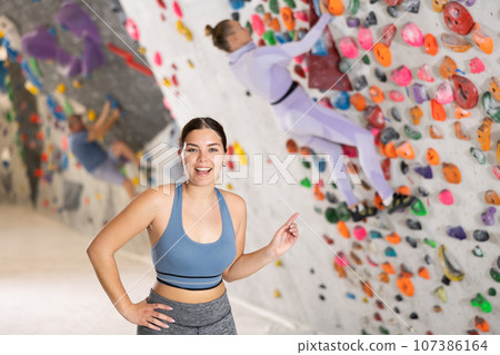Young woman posing on climbing wall 107386164
