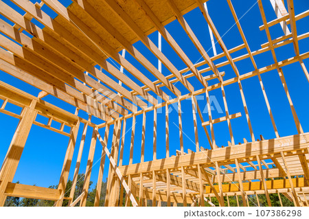 In construction new house roof, wooden frame trusses are used as support beams In construction new house roof, wooden frame trusses are used as support beams 107386298
