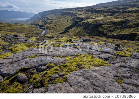 Berufjardara River and Fossarfell mountain in eastern Iceland on sunny morning. 107386866