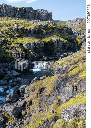 Berufjardara River and Fossarfell mountain in eastern Iceland on sunny morning. Berufjardara River and Fossarfell mountain in eastern Iceland on sunny morning. 107386868