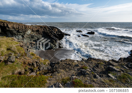 Rugged east coast of Iceland on sunny autumn morning with very strong wind. 107386885
