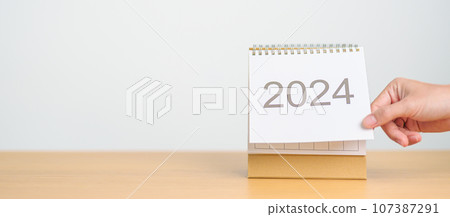 2024 Year Calendar on table background. Happy New Year, Resolution, Goals, Plan,  Action, Mission and financial Concept 107387291