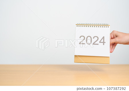 2024 Year Calendar on table background. Happy New Year, Resolution, Goals, Plan,  Action, Mission and financial Concept 107387292