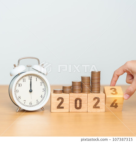 Happy New Year with vintage alarm clock and flipping 2023 change to 2024 block. Resolution, Goals, Plan, Action, Money Saving, Retirement fund, Pension, Investment and Financial concept 107387315
