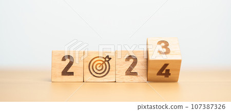 2023 year change to 2024 year block with dartboard icon. Goal, Target, Resolution, strategy, plan, Action, mission, motivation, and New Year start concepts 107387326