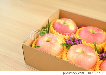 beautiful pink apple in the box on wood floor, healthy fruit beautiful pink apple in the box on wood floor, healthy fruit 107387710