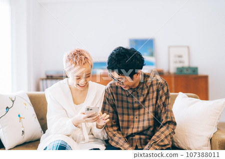 Couple looking at a smartphone together 107388011