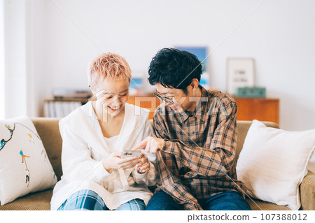 Couple looking at a smartphone together 107388012