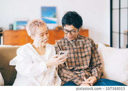 Couple looking at a smartphone together 107388013