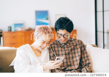Couple looking at a smartphone together 107388014