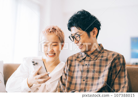 Couple looking at a smartphone together 107388015