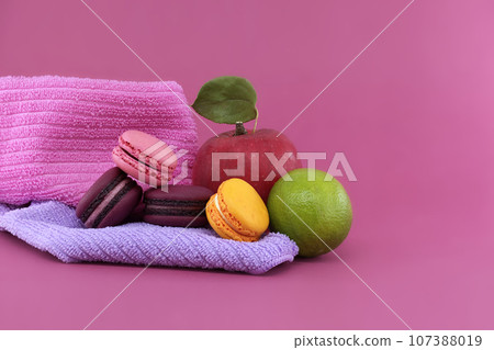 Group of colorful French macaroons and fruits 107388019