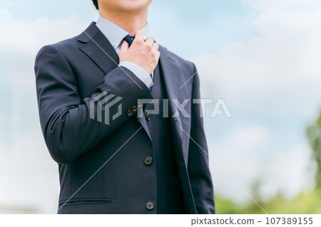 Young Asian businessman adjusting his tie Young Asian businessman adjusting his tie 107389155