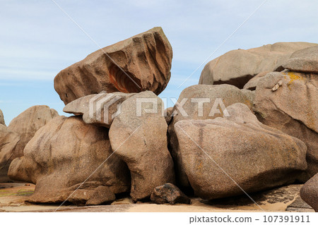 Bizarre boulders and rocks on the Pink Granite Coast on the island of Renote in Brittany 107391911