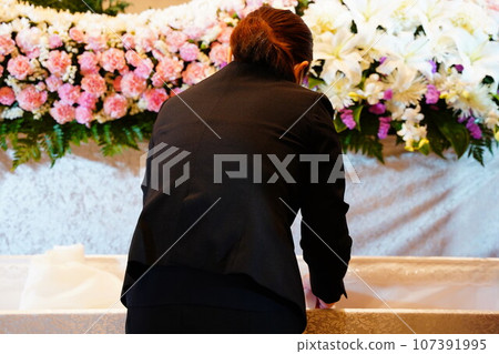 Ceremony lady preparing the deceased's appearance 107391995