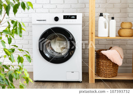 Modern white washing machine close up photo Modern white washing machine close up photo 107393732