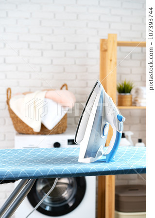 Ironing board at laundry room with washing machine Ironing board at laundry room with washing machine 107393744
