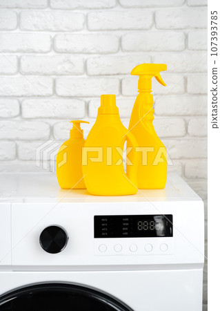 Laundry washing detergents containers on washing machine 107393785