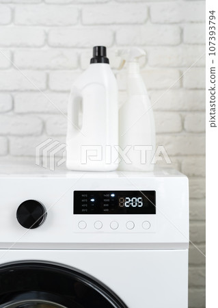 Laundry washing detergents containers on washing machine 107393794
