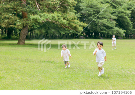 Active children chasing each other in the park, siblings, running, sprinting 107394106