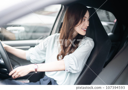 A young woman in business casual clothes checking the rear 107394593