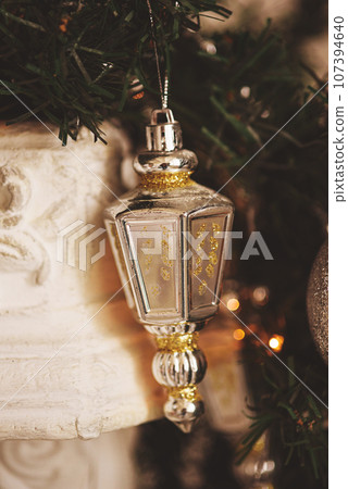 Silver Christmas decoration on a fir branch. Silver Christmas decoration on a fir branch. 107394640