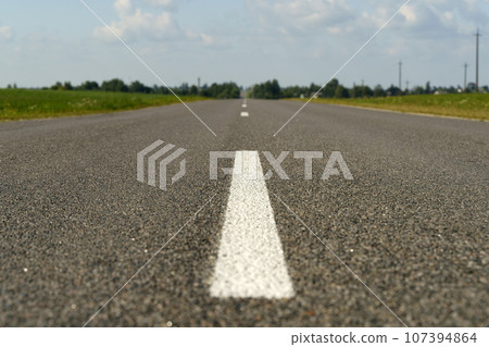 Automobile road with asphalt and framed in summer. Empty straight road. 107394864