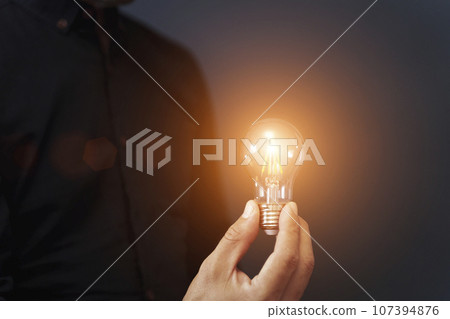 Knowledge idea bulb concept. Electric light bulb in hand business manager. Innovation, brain, creative concept 107394876