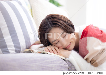 A woman taking a nap in the living room 107394901