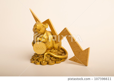 A figurine of a mouse with a gold coin. Decrease in gold price. Gold price decrease in commodity trading bear market investment concept. Gold is store of value in recession crisis 107396611