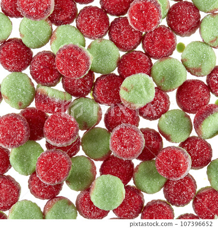 Texture of randomly scattered gelatin candies of red-green colors, in the form of buns sprinkled with sugar. Texture of randomly scattered gelatin candies of red-green colors, in the form of buns sprinkled with sugar. 107396652