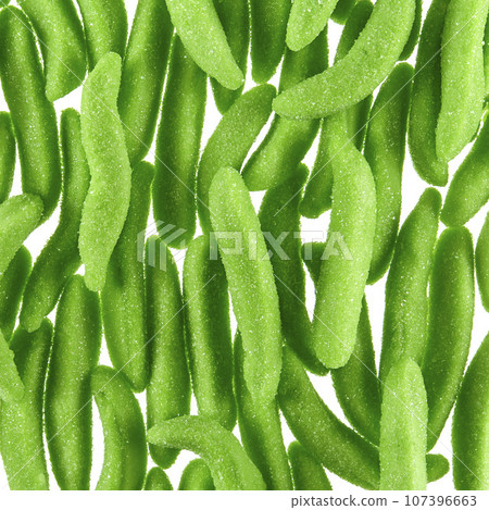 Texture of randomly scattered gelatin candies made in the form of green pea pods sprinkled with sugar. Texture of randomly scattered gelatin candies made in the form of green pea pods sprinkled with sugar. 107396663