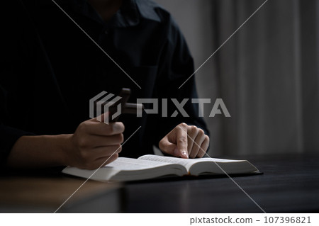 Closeup of simple wooden Christian cross on Bible. Concept of hope, faith, christianity, religion. 107396821