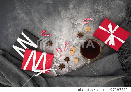 Christmas concept with coffee cup, candy, sugar and gifts on gray. Flat lay Christmas concept with coffee cup, candy, sugar and gifts on gray. Flat lay 107397261