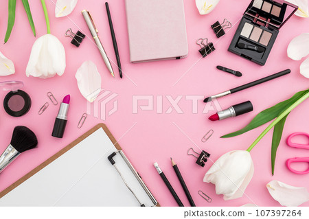 Beauty blogger composition with clipboard, flowers, cosmetics and accessory isolated on pink background. Top view. Flat lay. Beauty blogger composition with clipboard, flowers, cosmetics and accessory isolated on pink background. Top view. Flat lay. 107397264