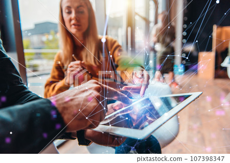 Businessman works in office with a tablet. Concept of internet sharing Businessman works in office with a tablet. Concept of internet sharing 107398347