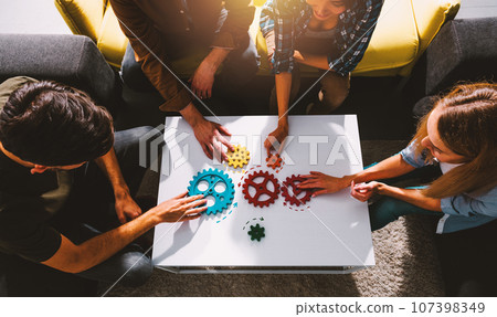 Business team work together and combine pieces of gears. Partnership and integration concept 107398349
