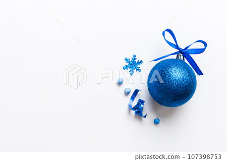 Christmas ball on colored background. decoration bauble with ribbon bow with copy space 107398753